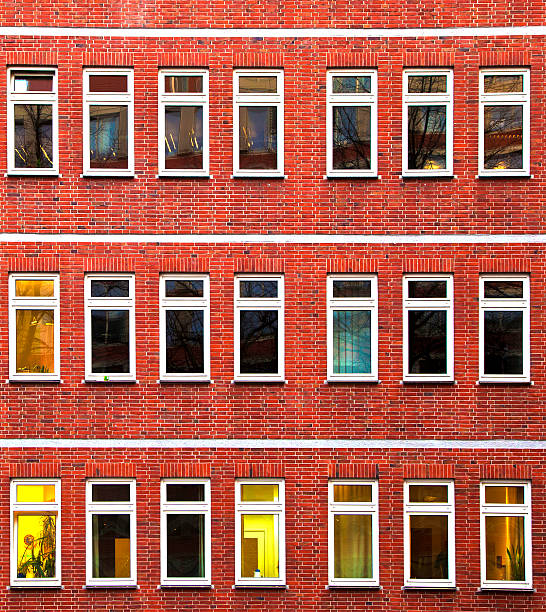 facade of office building in the evening with illuminated windows