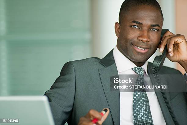 Empresario Atractivo En El Teléfono Foto de stock y más banco de imágenes de Afrodescendiente - Afrodescendiente, Hombres, Oficina