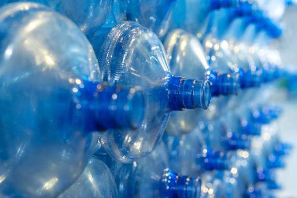istock Gallon-sized plastic drinking water bottles arranged in a neat and orderly manner within a mineral water factory. Bottles await the filling process, representing the initial stage of production. 1540114088