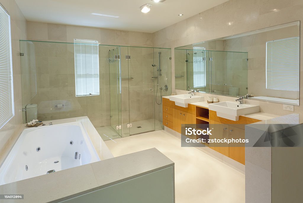 Modern twin bathroom Modern marble bathroom with twin sinks, shower and bath tub Apartment Stock Photo