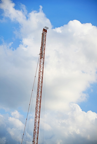 Vertical crane against is up on the blue sky background