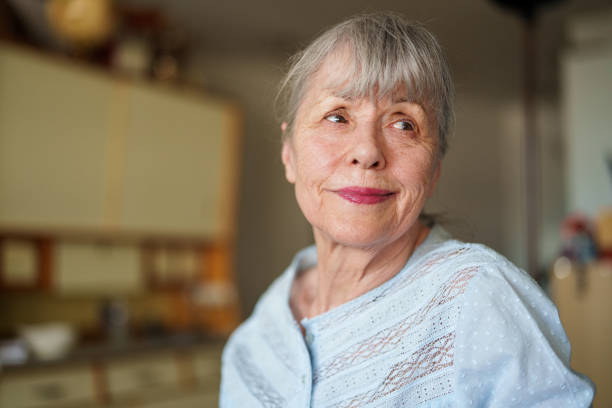 istock Senior woman standing indoors while looking away 1540160547