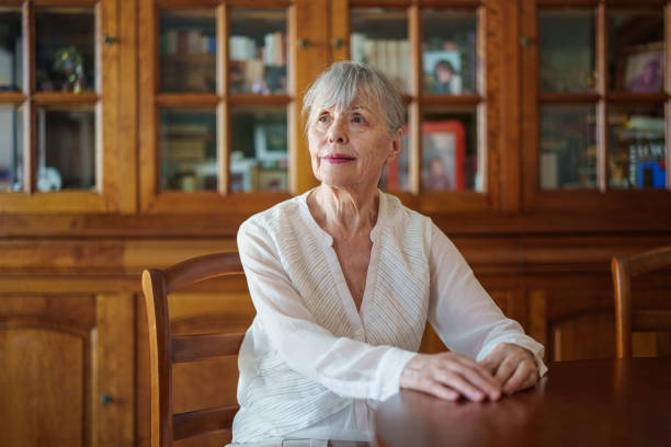 istock Senior woman sitting indoors at dining table 1540163694