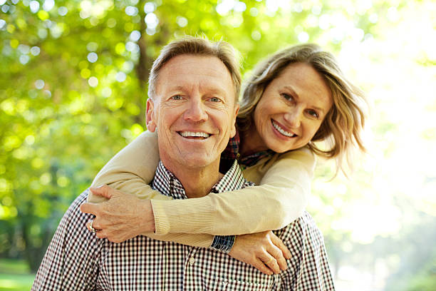 istock Man carrying his wife on piggy back 154018082