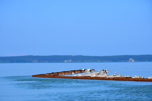 A View Of A Small Wave Breaking System Made Out Of Metal Poles And a-view-of-a-small-wave-breaking-system-made-out-of-metal-poles-and