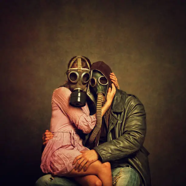 Young post apocalyptic couple hugging each other. Added brown tone, grain, damage, textures and vignetting for the mood.