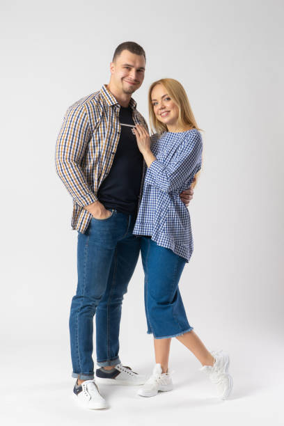istock Man and woman hugging while looking at the camera. A young married couple. 1540196545