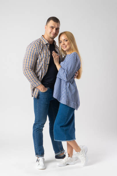 istock Man and woman hugging while looking at the camera. A young married couple. 1540196786