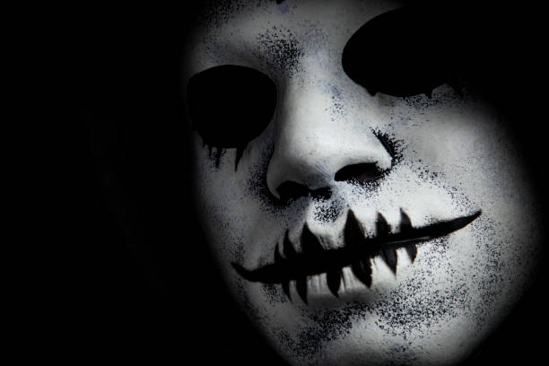 A close up of a spooky painted Halloween mask.