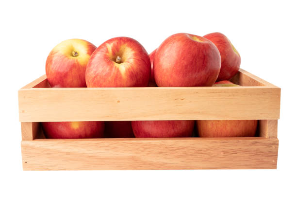 beautiful pink apple in the box on green background, healthy fruit