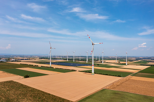 Bird's-eye view of a wind farm and a photovoltaic free-field system in between in Rhineland-Palatinate near Wörrstadt/Germany in the middle of grain fields