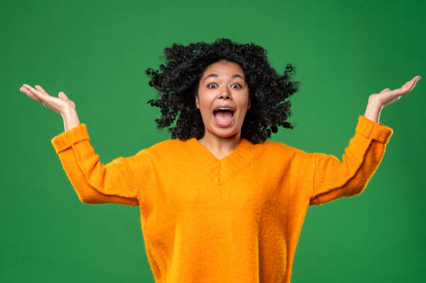 istock Dark-haired woman in orange looking stressed and shocked 1540224313
