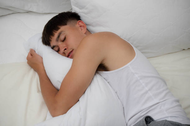 istock Young Man Sleeping in Clothes on Bed 1540232043