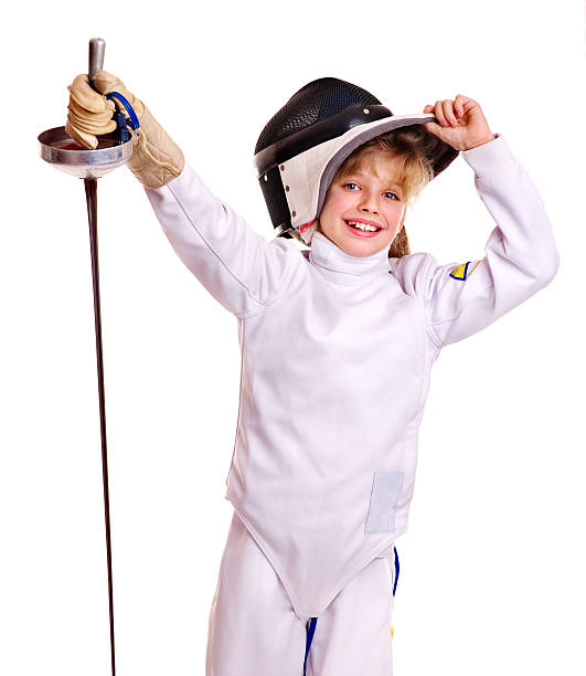 Child in fencing costume holding epee . stock photo