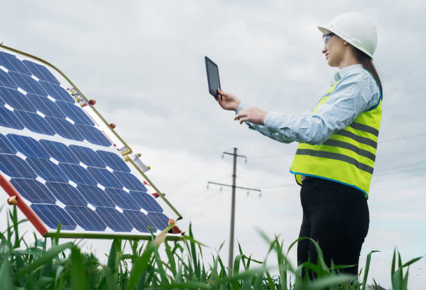 istock Portrait of a technical engineer with a tablet in his hands, standing in front of an unfinished tall outdoor solar panel of a photovoltaic system, technical engineer girl 1540255694