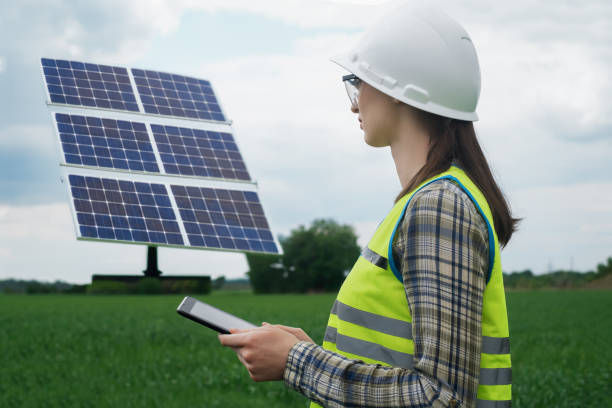 istock Portrait of a technical engineer with a tablet in his hands, standing in front of an unfinished tall outdoor solar panel of a photovoltaic system, technical engineer girl 1540255814