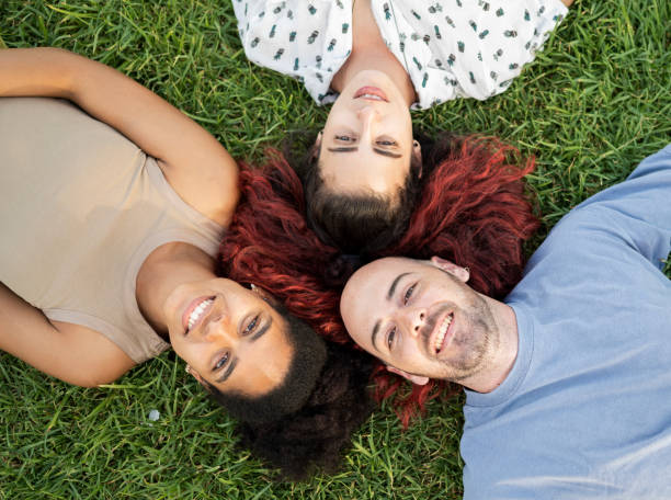 istock Friends lying on the grass of a park 1540279080