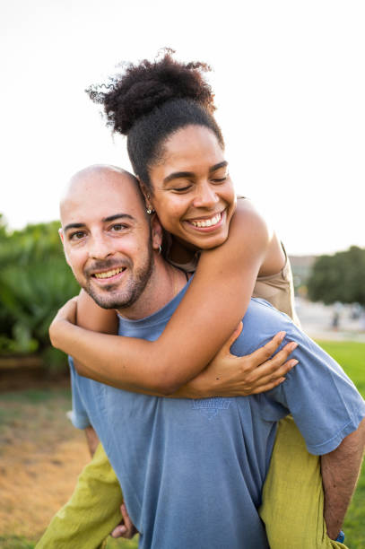 istock Couple piggybacking on a park during sunset 1540280702