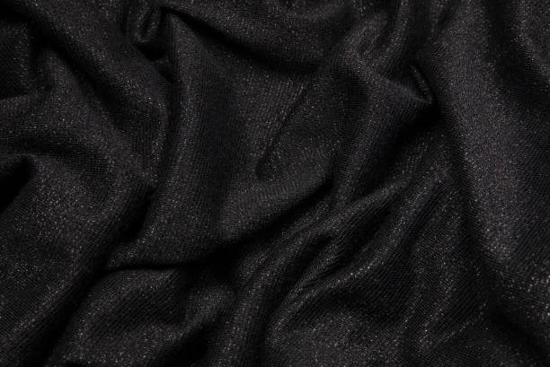 istock Smooth shiny fabric texture with folds and wawes. Close up silk background 1540288567