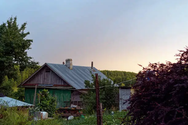 Rural house at sunset in summer, Russia