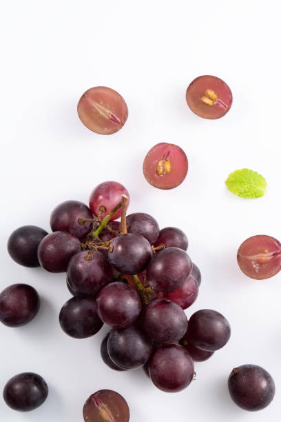 istock Delicious bunch of grapes fruit spilled over white table background. 1540308905
