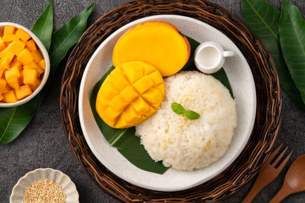 istock Delicious Thai mango sticky rice with cut fresh mango fruit in a plate. 1540309417