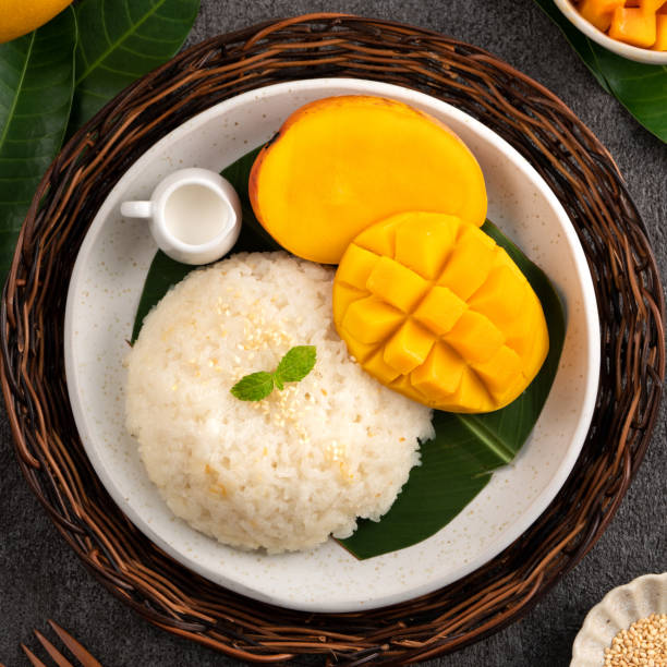 istock Delicious Thai mango sticky rice with cut fresh mango fruit in a plate. 1540309424