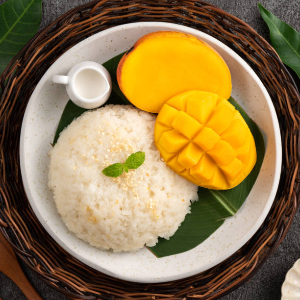 istock Delicious Thai mango sticky rice with cut fresh mango fruit in a plate. 1540312154