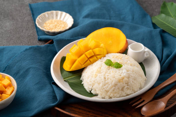 istock Delicious Thai mango sticky rice with cut fresh mango fruit in a plate. 1540312745