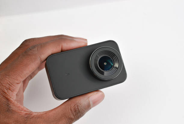 Capture every move and adventure with this black 4K action camera, strategically placed on the table.