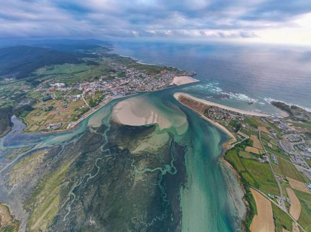 Tidal formations underneath the sea in lagoon beside the beach on the Costa Verde in Spain