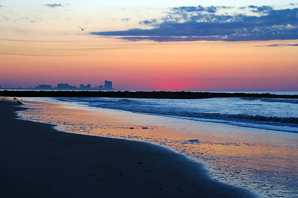 Dawn over the Atlantic Ocean as seen with Atlantic City, NJ in the distant background