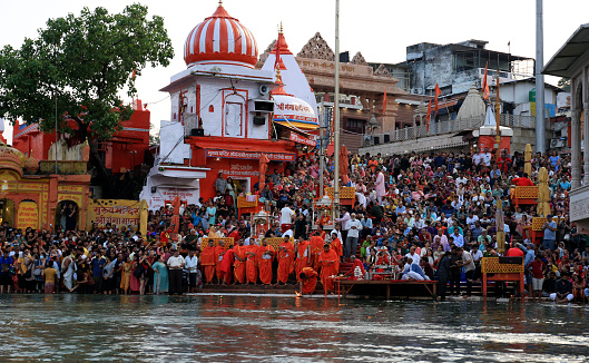 Haridwar, Uttarakhand, India –  May 02, 2023: Group of Hindu people gathered together for evening Aarti or religious offering of River Ganges.