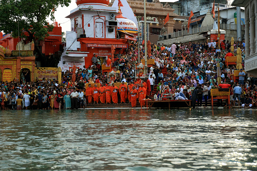 Haridwar, Uttarakhand, India –  May 02, 2023: Group of Hindu people gathered together for evening Aarti or religious offering of River Ganges.