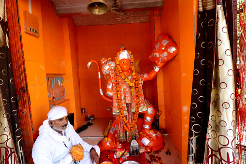 Haridwar, Uttarakhand, India –  May 02, 2023: Hindu devotee sitting in Lord Hanumana Temple at Haridwar, Uttrakhand, India.