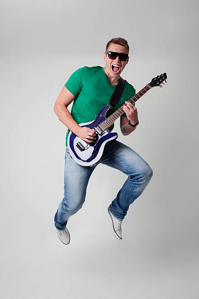 istock Rockstar leaping with guitar 154035314