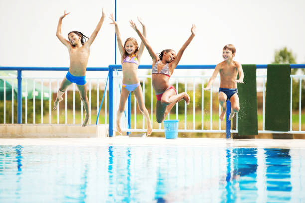 istock Happy kids playing and having fun together in the pool. 154035601