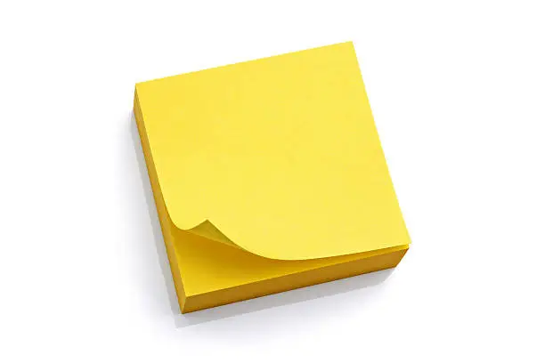 Blank yellow sticky note block isolated on white background