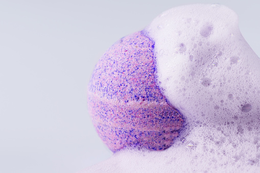 Pink bath bomb with soap on white background closeup. Sea salt in a ball shape for beauty spa treatment and body care.
