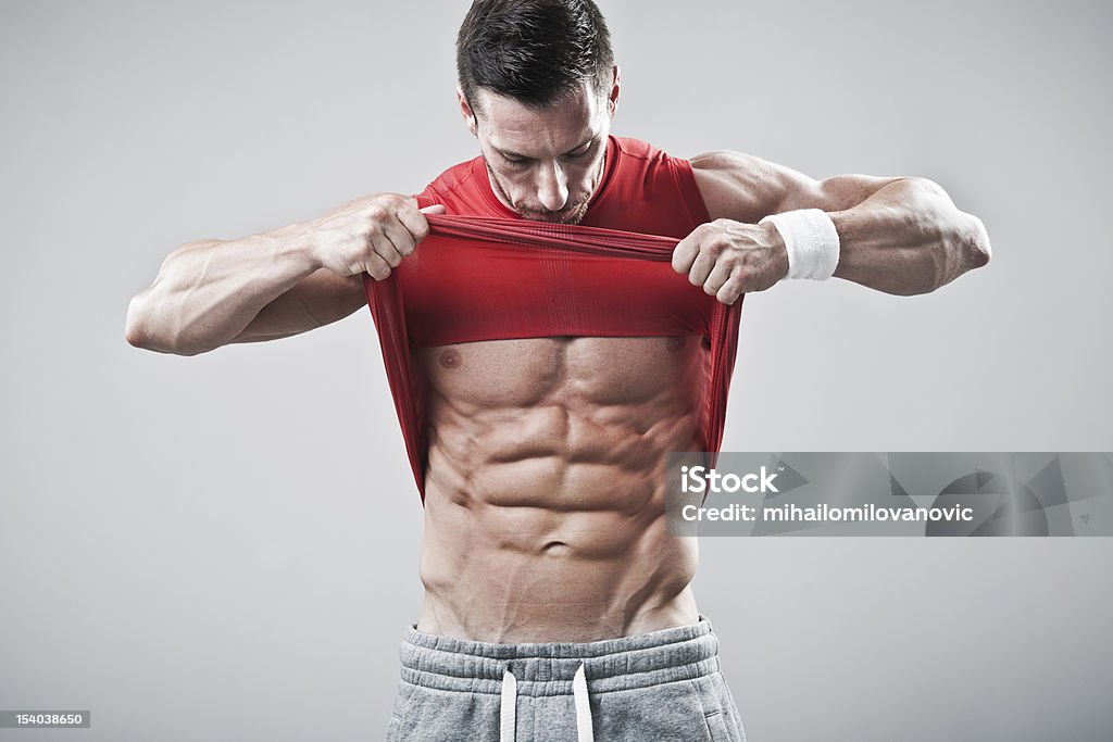 Handsome man showing his abs Handsome muscular man, showing his abdominal muscles. Abdomen Stock Photo