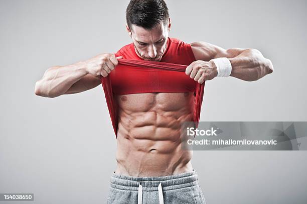 Handsome Man Showing His Abs Stock Photo - Download Image Now - Abdomen, Abdominal Muscle, Adult