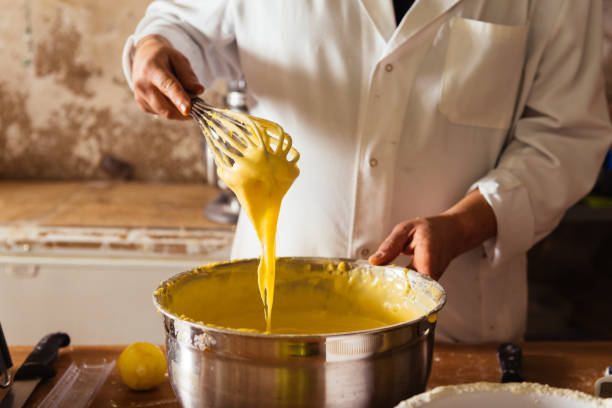 istock Unrecognizable man standing and preparing cream on table 1540387170