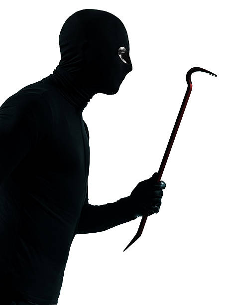 istock thief criminal holding crowbar portait 154039027