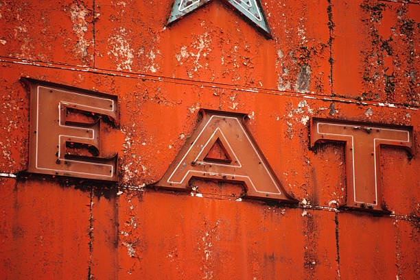 istock Old weathered Neon sign spelling out EAT 154039049