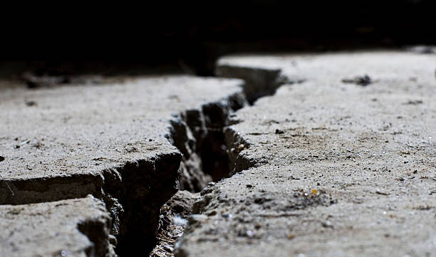istock cracked road concrete close up 154039097