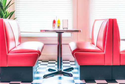 Bright red colored vinyl seating at a diner in Los Angeles, USA.