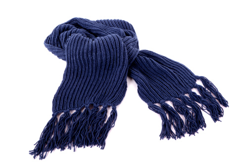 Blue winter scarf with tassels or fringe isolated against a white background.