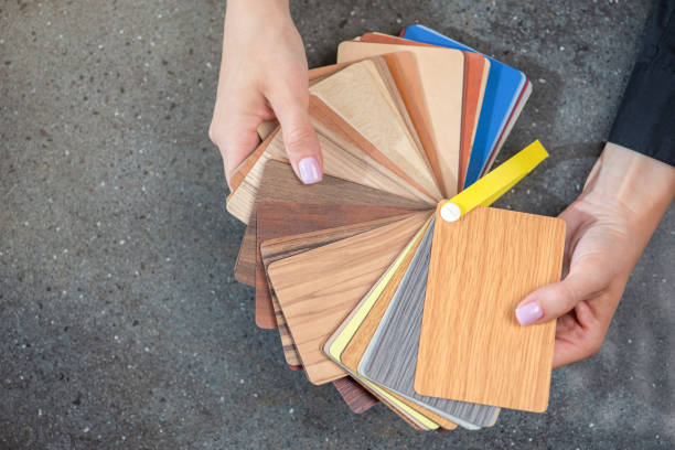 istock laminate samples. The choice of laminated surface for chipboard. Samples of wood imitation laminate in hands, close-up. 1540467281