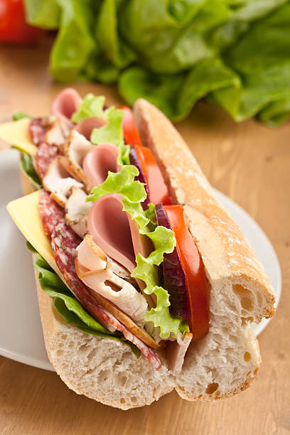 istock long subway baguette sandwich with meat, vegetables and cheese 154047315