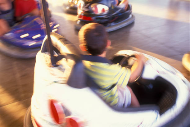 istock Boy driving a bumper car in an amusement park 1540498866